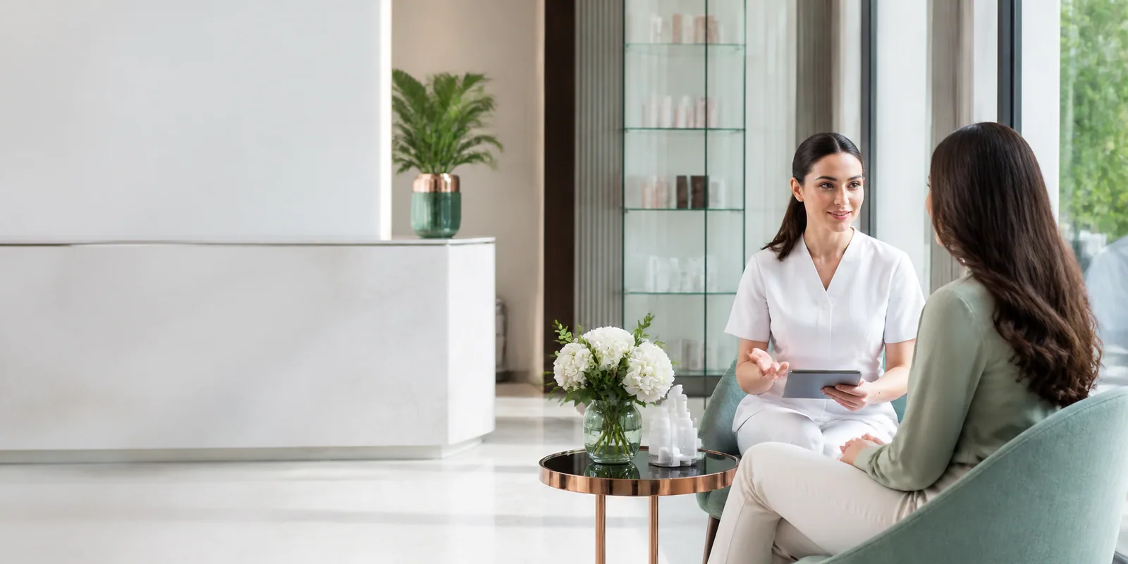 Professional beauty specialist consulting with a client in a modern beauty center